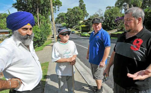 Cr John Arkan (left) listens to the concerns about traffic problems of Sandy Beach residents Ken Bray, Bluey Menon and Don Johnson. Cr John Arkan (left) listens to the concerns about traffic problems of Sandy Beach residents Ken Bray, Bluey Menon and Don Johnson.